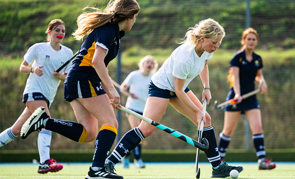 Image of pupils playing in a hockey fixture