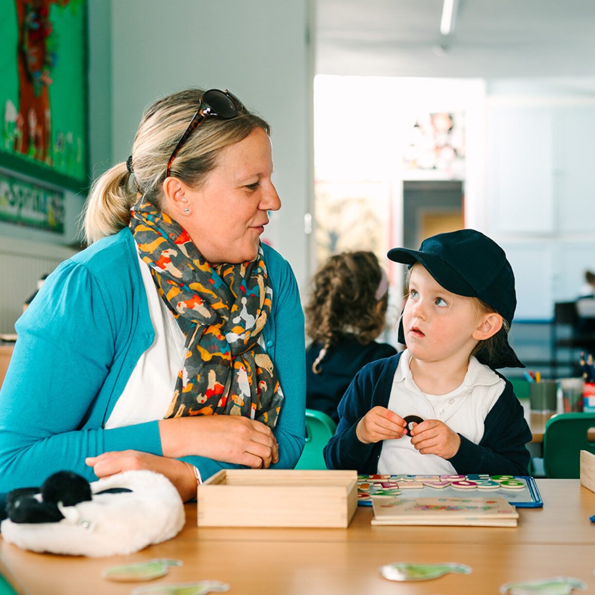 Pre-prep school teacher with child