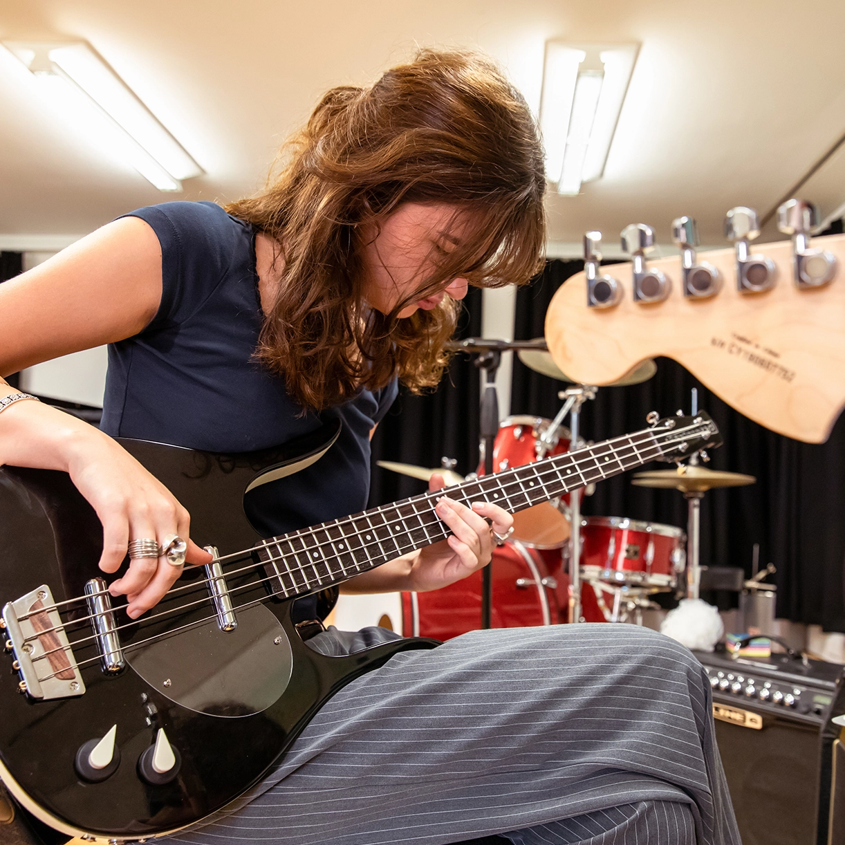 Playing guitar in music recording studio