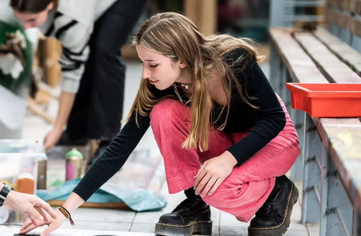 Girl doing art on floor