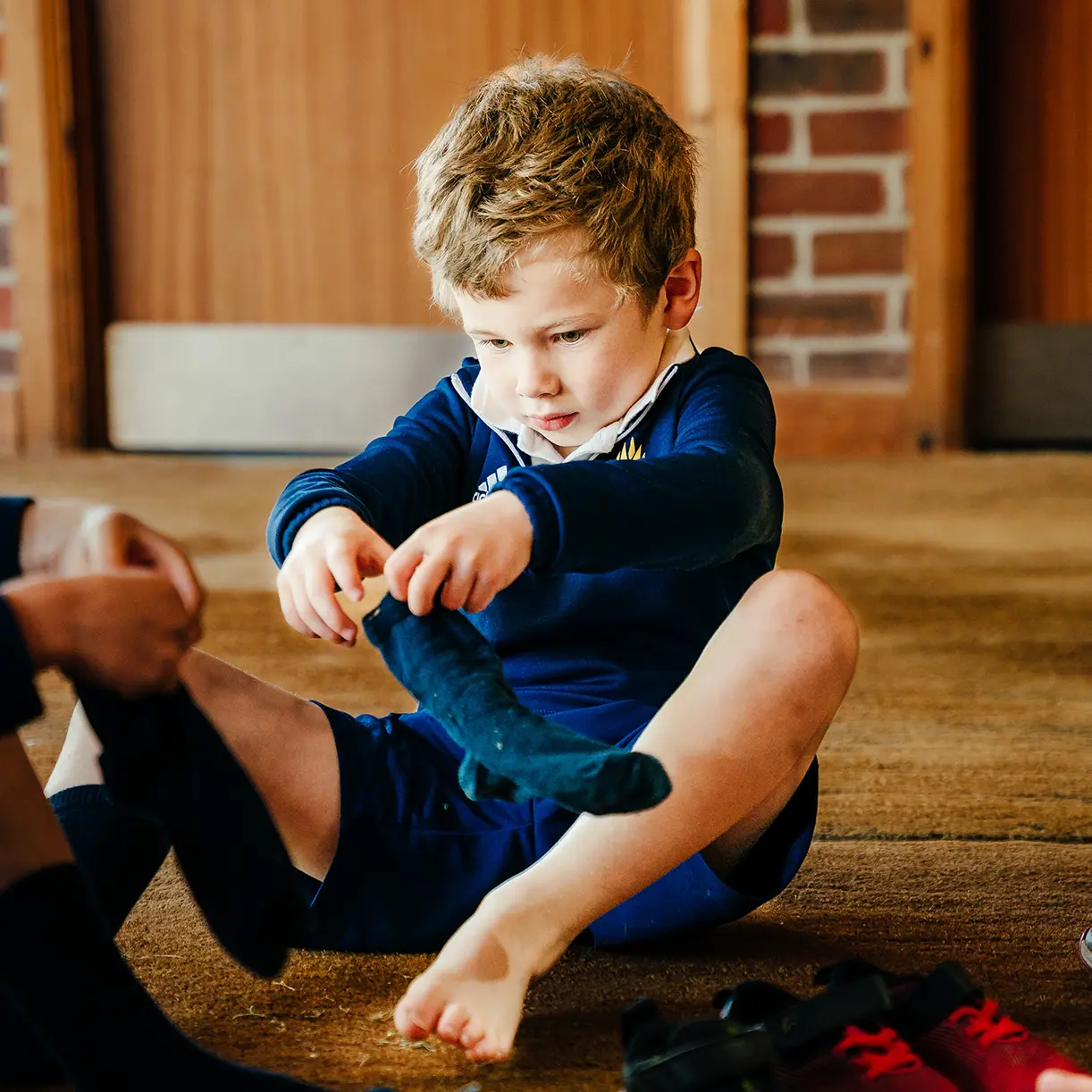Prep school boy getting dressed