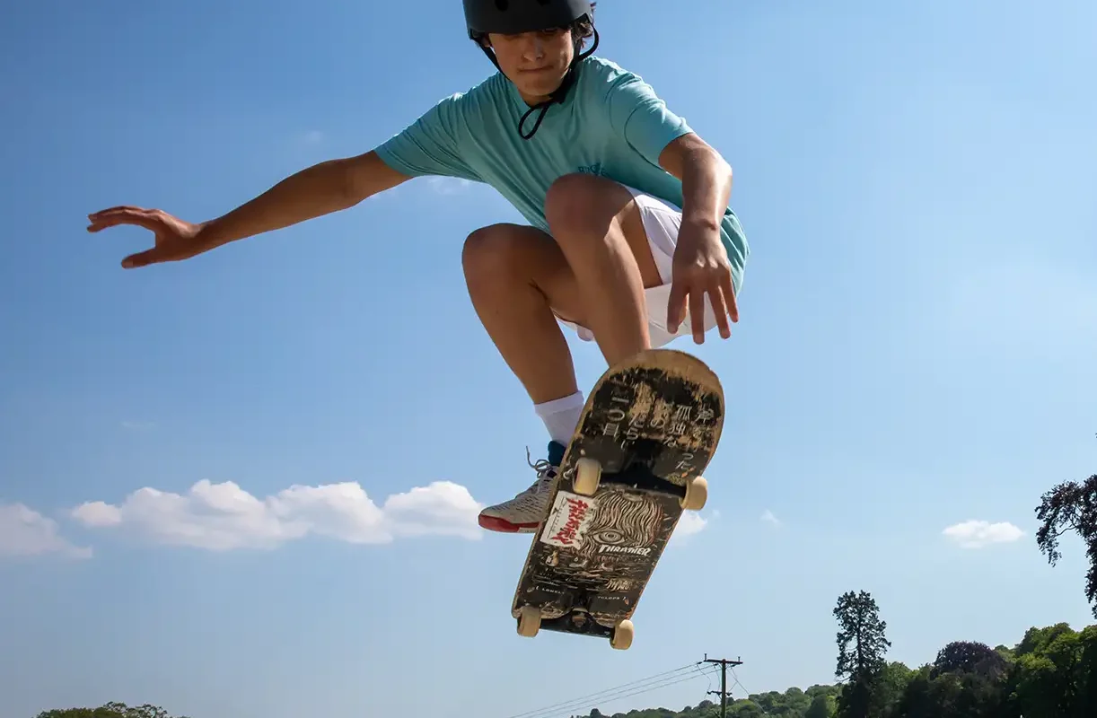 Skateboarding boy in air