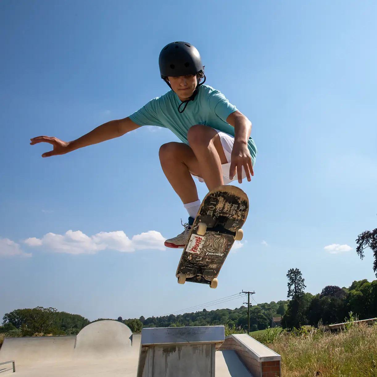 Skateboarding boy in air