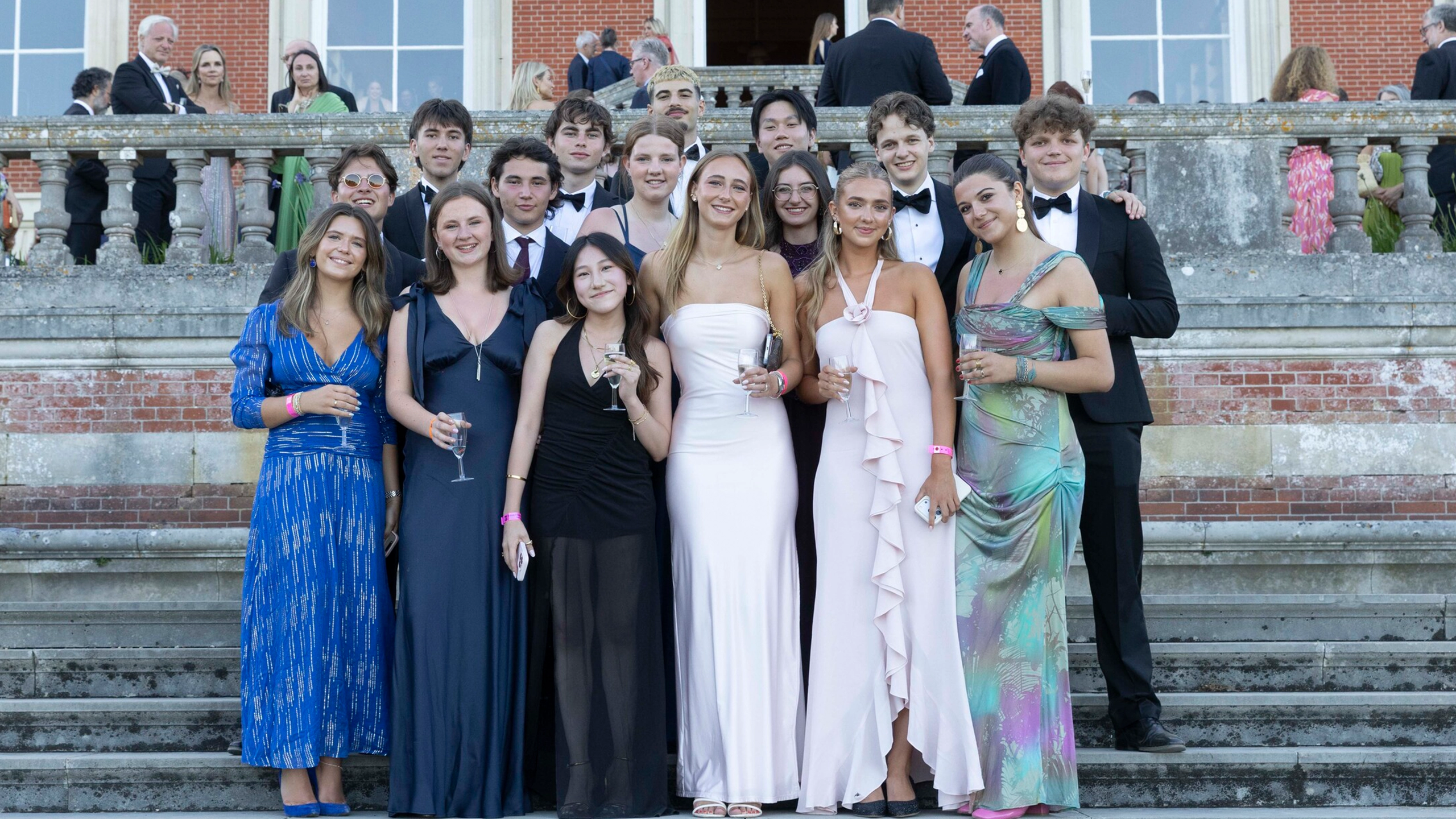 students posing for picture at leavers ball 2026 on the steps outside building